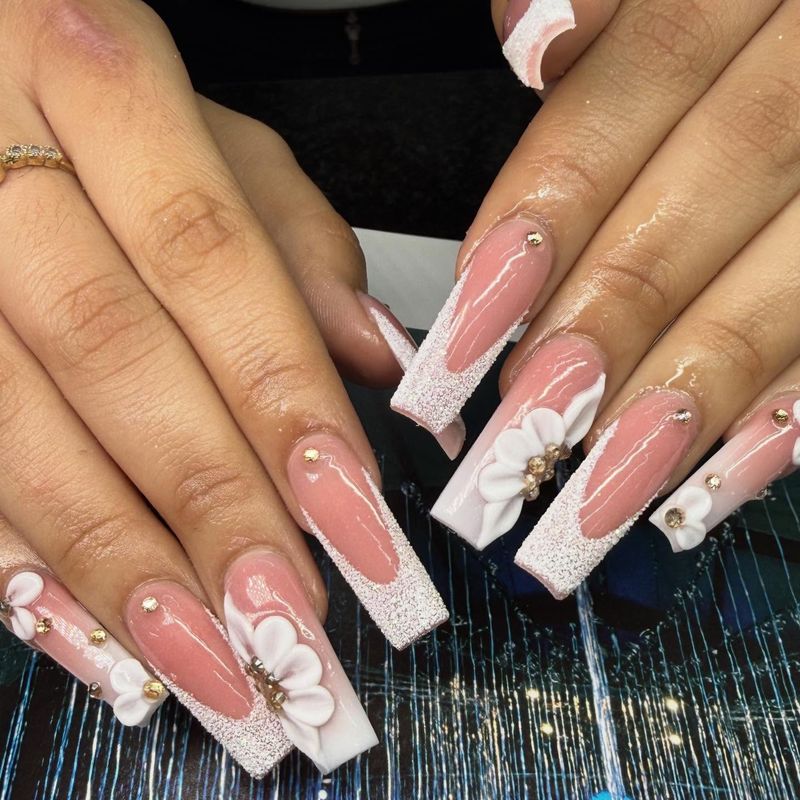 Pink coffin nails with white floral art by Nini Nail Bar