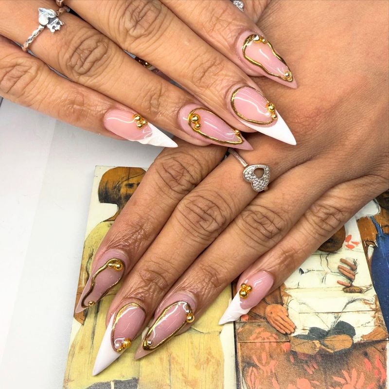Nude stiletto nails with abstract line art by Nini Nail Bar